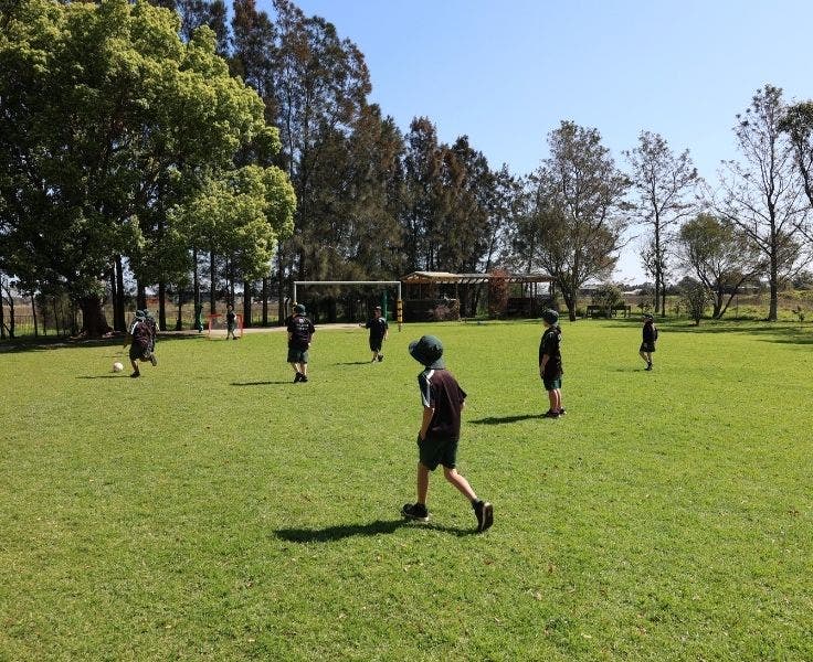 Students on the playground playing soccer.