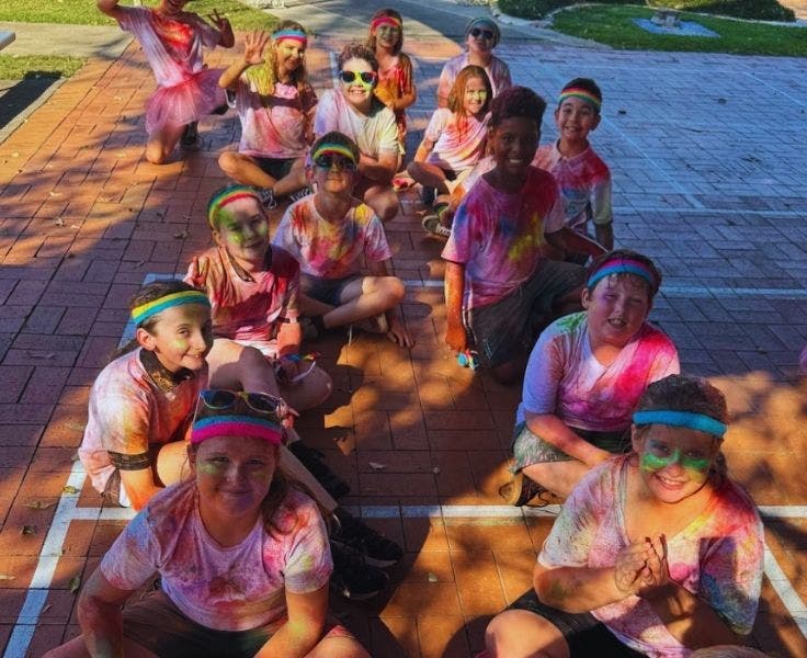 Students covered in colourful powder after a colour run.